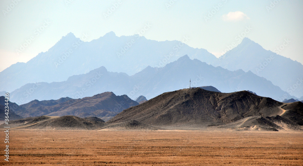 Panorama of a mountain range in the Arabian desert. An example of the sultry tonal perspective of the Egyptian open spaces. In the vicinity of Hurghada, Egypt.