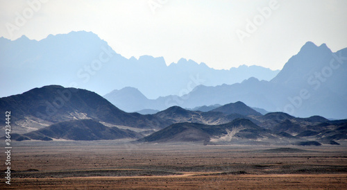 Panorama of a mountain range in the Arabian desert. An example of the sultry tonal perspective of the Egyptian open spaces. In the vicinity of Hurghada, Egypt.