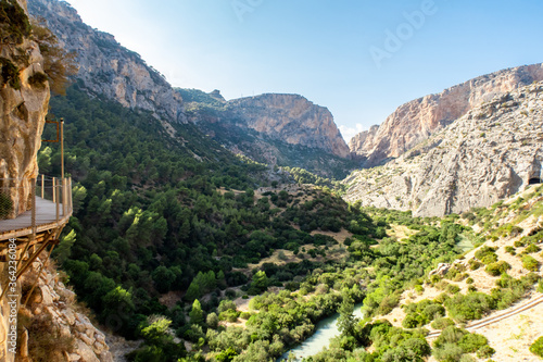Mountain landscape view of El Chorro narrow gorge and El Caminito del Rey walkway wooden platforms attached to vertical rocks over the precipice, no people, Spain.