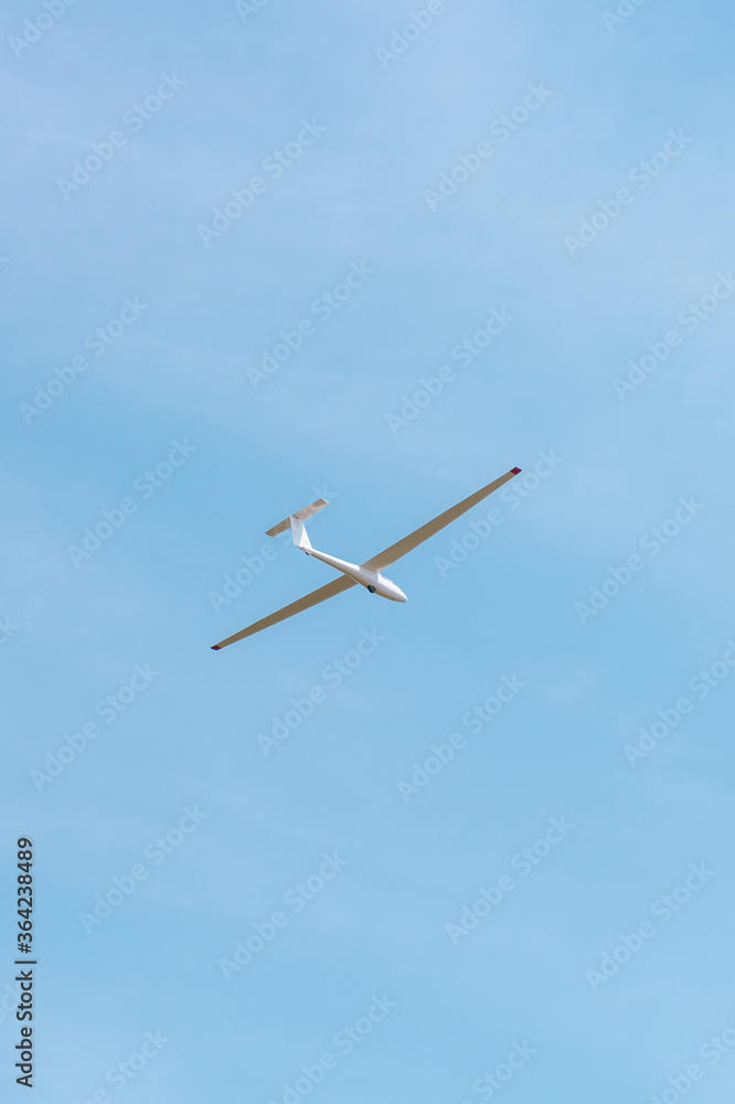Small glider flying against the pink sky, concept of dream, happy future and positive outlook on life Small glider flying against the pink sky, concept of dream, happy future and positive outlook on life