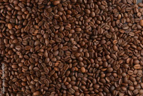 Coffee beans close-up. Roasted coffee beans background, top view.
