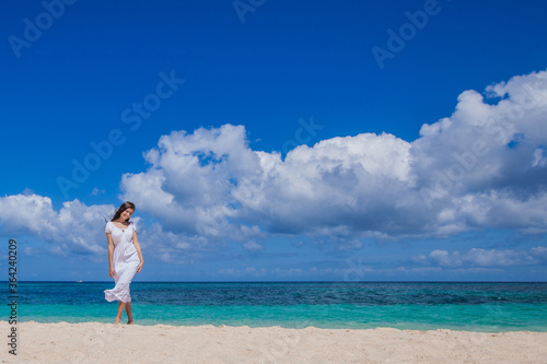 Woman in dress walking on beach