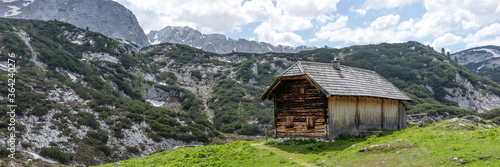 Wooden hut in the austrian alps. Panoramic image. Austria