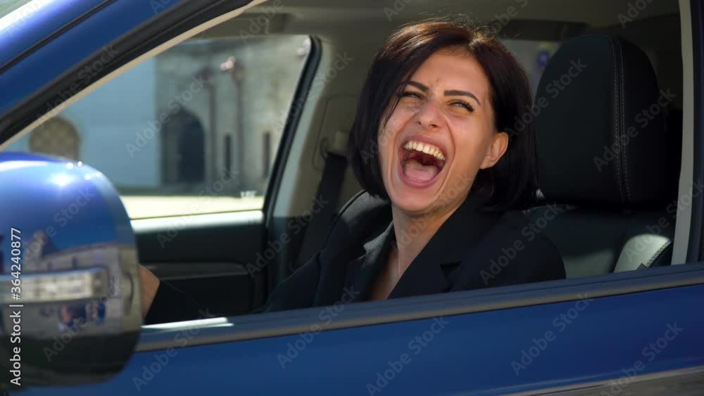 Funny beautiful businesswoman laugh in car salon Funny beautiful businesswoman laugh in car salon