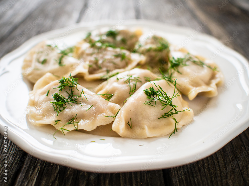 Dumplings - noodles with meat on wooden table Dumplings - noodles with meat on wooden table