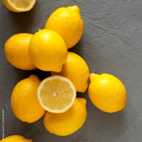 Valokuva Fresh Ripe Yellow Organic Lemons on gray surface, overhead view