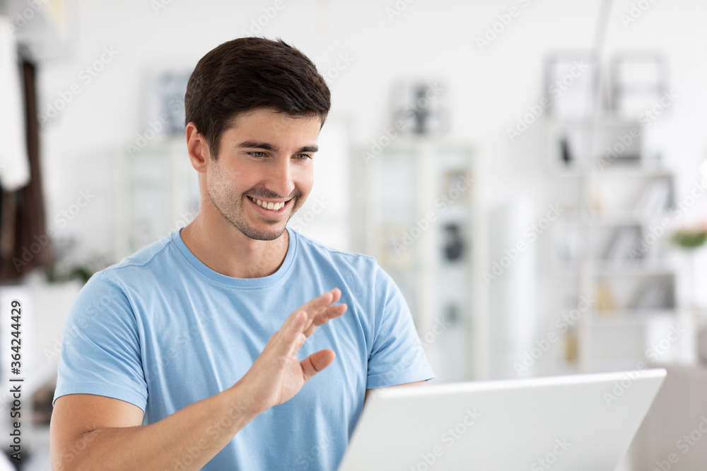 Happy millennial man, enjoying watching educational webinar on laptop. Smiling guy holding video call. Happy millennial man, enjoying watching educational webinar on laptop. Smiling guy holding video call.