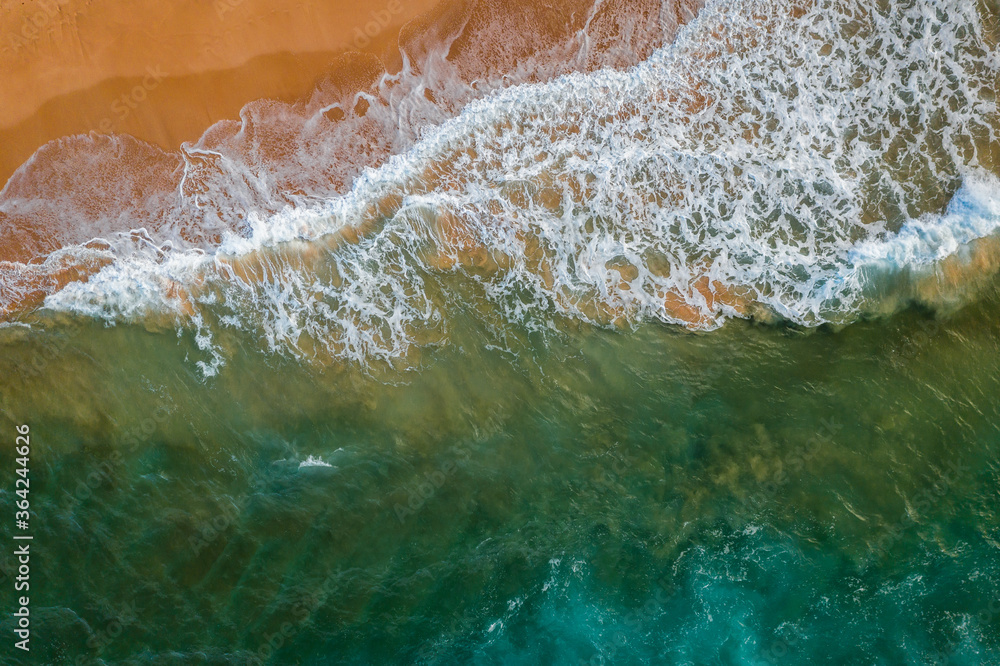 An aerial view of waves crashing on a beach , New South Wales in the morning