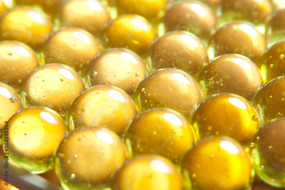 golden vitamins Omega-3 close-up background golden vitamins Omega-3 close-up background