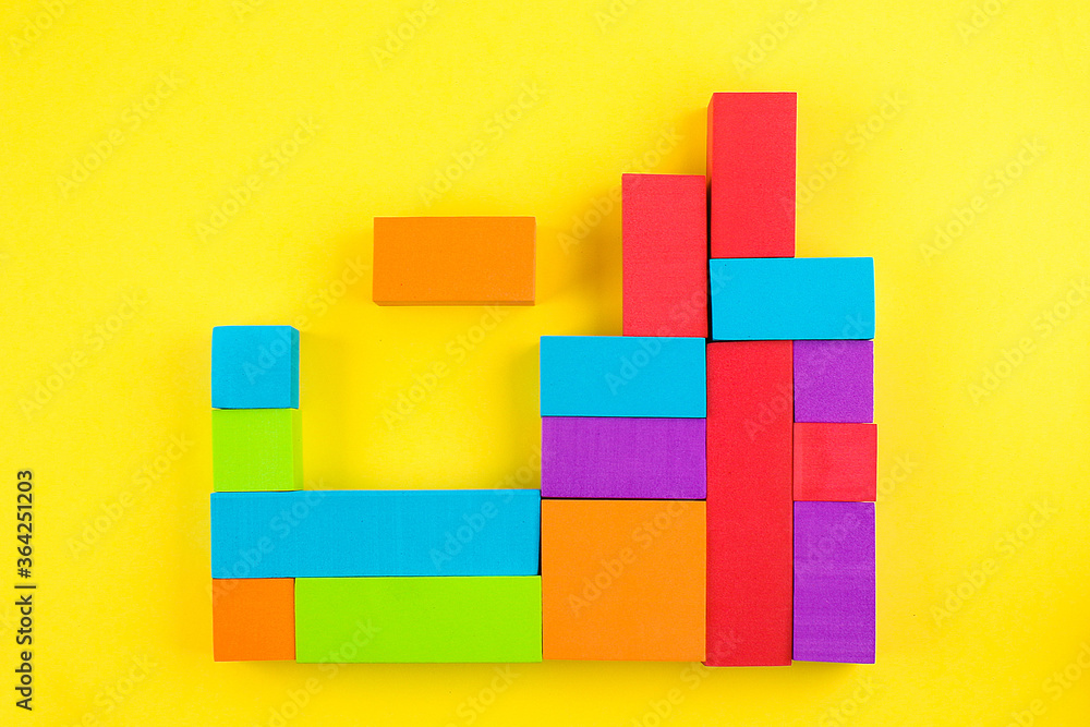 Kids designer of multi-colored volumetric 3d geometric shapes on yellow background. Logical educational game. Kids designer of multi-colored volumetric 3d geometric shapes on yellow background. Logical educational game.
