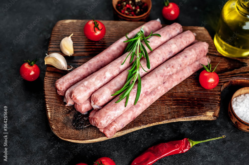 Thin raw meat sausages on a stone background
Thin raw meat sausages on a stone background
