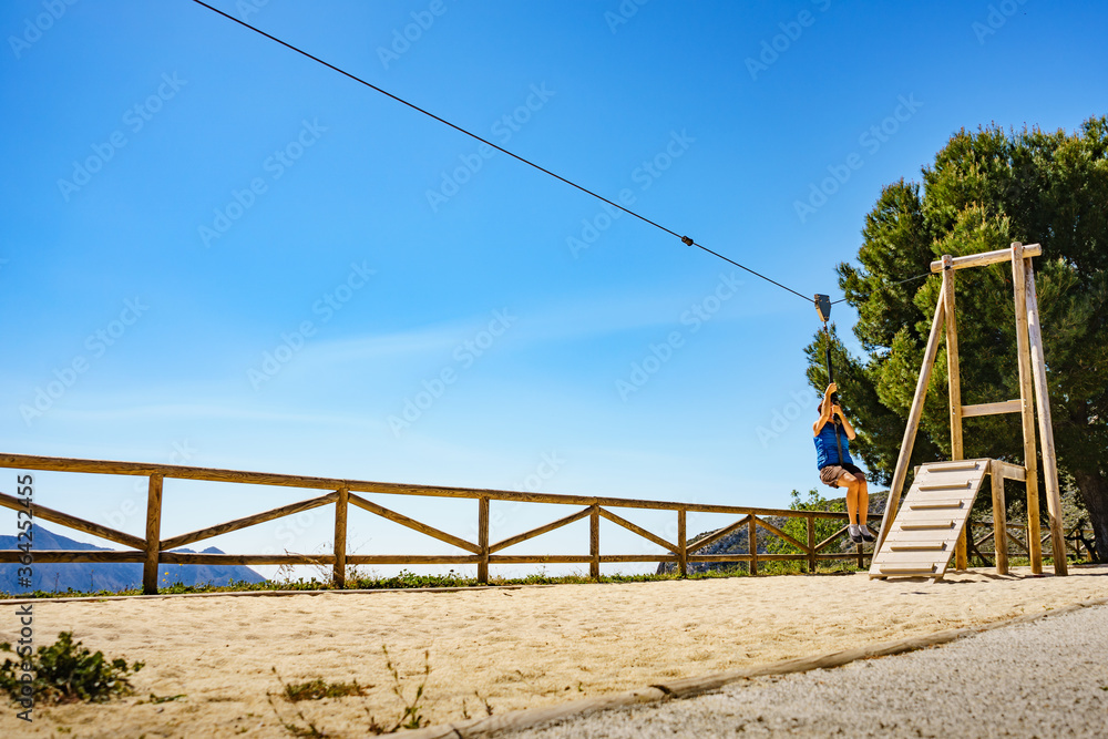 Adult woman having fun on zipline Adult woman having fun on zipline
