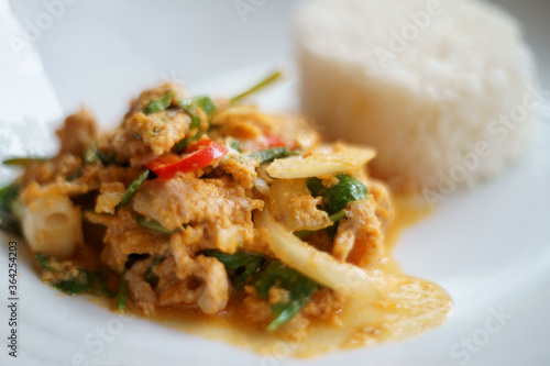 Rice with stir fried pork and kaffir lime leaves with panang curry on top,Thai food