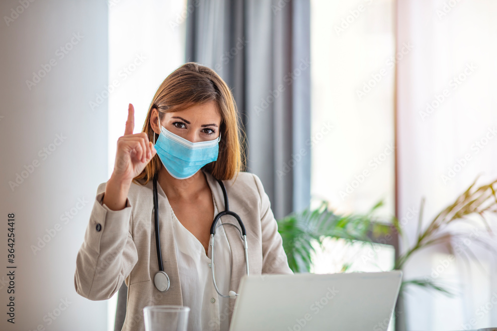 Doctor woman in protective medical mask, glasses sitting at table in office. Medicine, healthcare, people concept, portrait of professional confident specialist. Doctor woman in protective medical mask, glasses sitting at table in office. Medicine, healthcare, people concept, portrait of professional confident specialist.