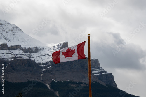 A picture of Canada flag waving against Mount Murchison. Banff National park AB Canada 