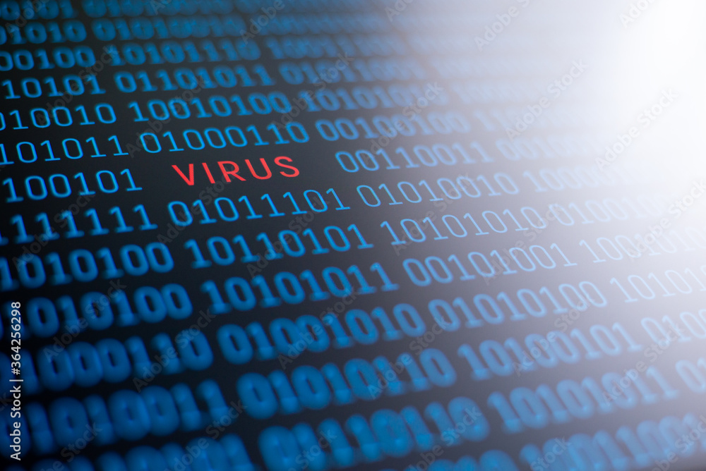 The word virus, written in red letters on a background of binary code in blue; white light on the right upper side. Concept of computer virus The word virus, written in red letters on a background of binary code in blue; white light on the right upper side. Concept of computer virus