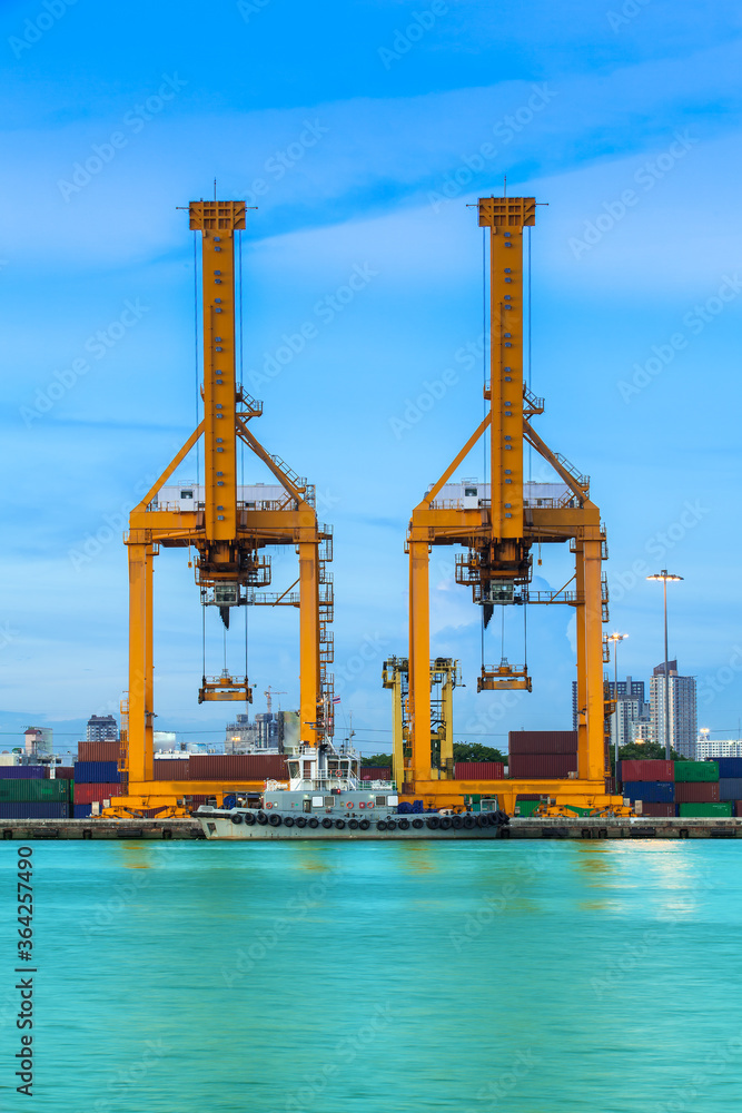 Working crane loading bridge in shipyard at dusk for Logistic Import Export background. Working crane loading bridge in shipyard at dusk for Logistic Import Export background.