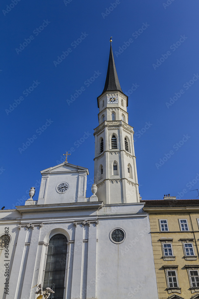 Fototapeta premium St. Michael's Church (Michaelerkirche) on Michaelerplatz in Vienna. St. Michael's Church dedicated to Archangel Michael is one of the oldest churches in Vienna. Austria.