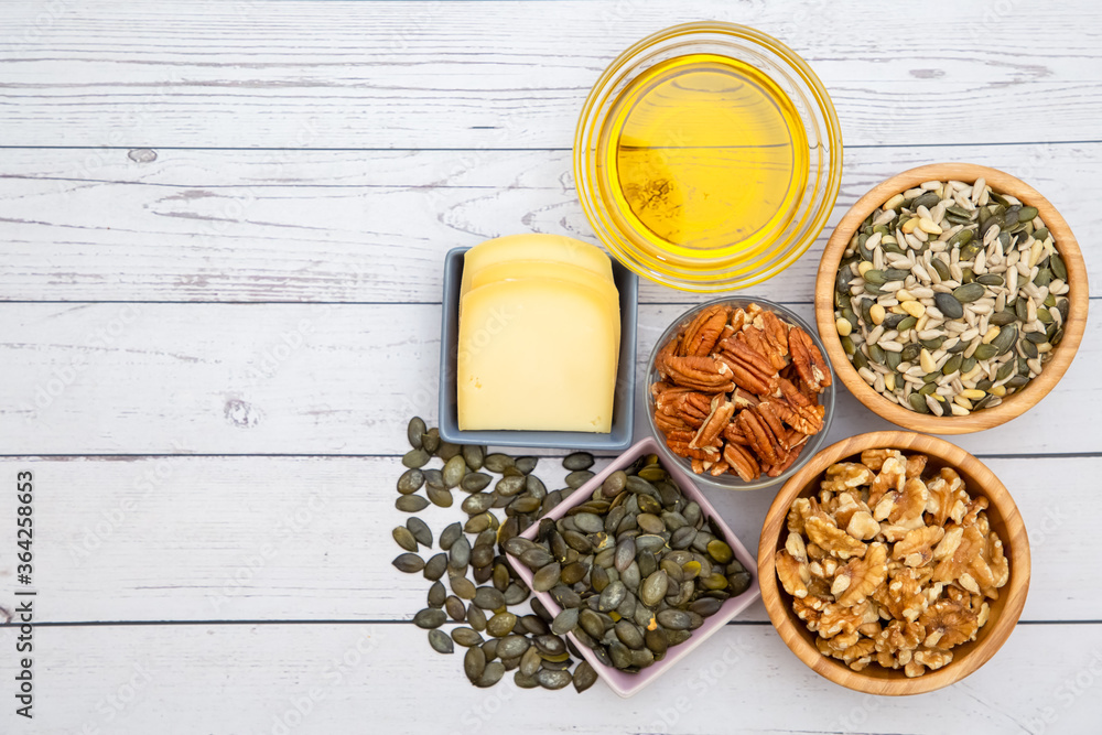 Group Nuts put on the bowl and egg, olive oil, cheeses the food healthy on the wooden table background Group Nuts put on the bowl and egg, olive oil, cheeses the food healthy on the wooden table background