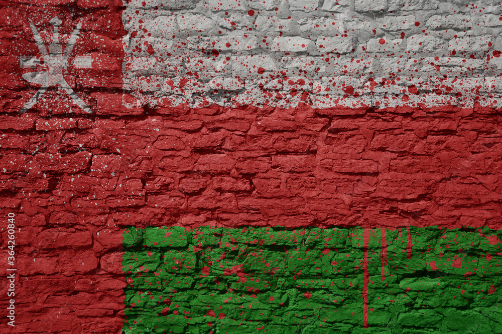 painted big national flag of oman on a massive old brick wall painted big national flag of oman on a massive old brick wall