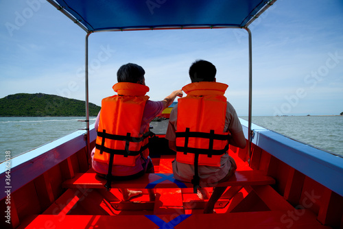 Two tourists travelling on longtail boat