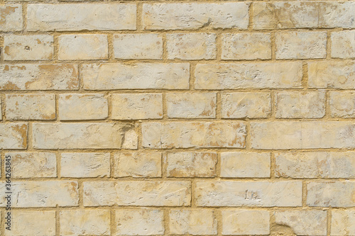 Panoramic background of yellow brick wall texture. Home or office design backdrop.