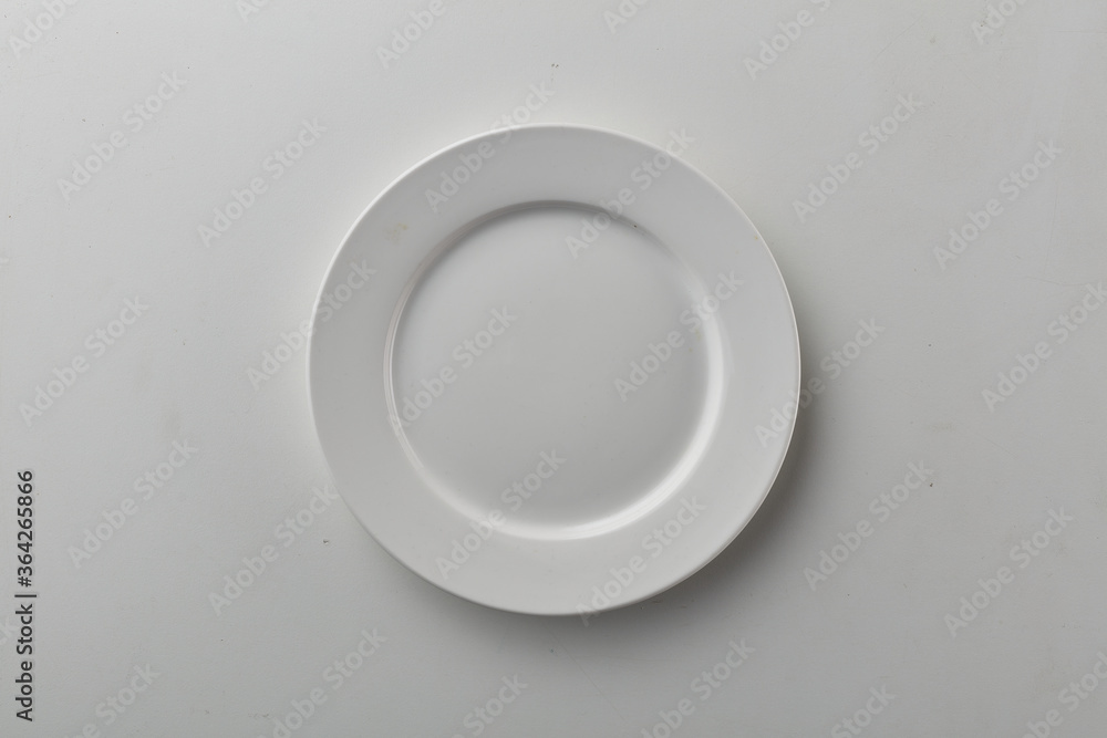 Top view shot of white circular plate. Top view shot of white circular plate.