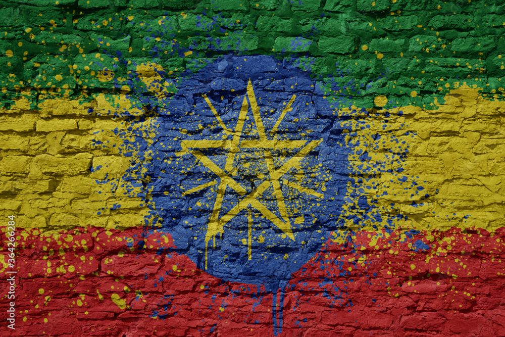 Fototapeta premium painted big national flag of ethiopia on a massive old brick wall
