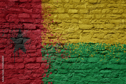 painted big national flag of guinea bissau on a massive old brick wall © luzitanija