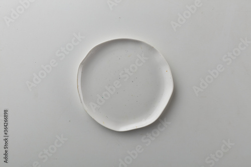 Top view shot of a rectangular white plate on white background.