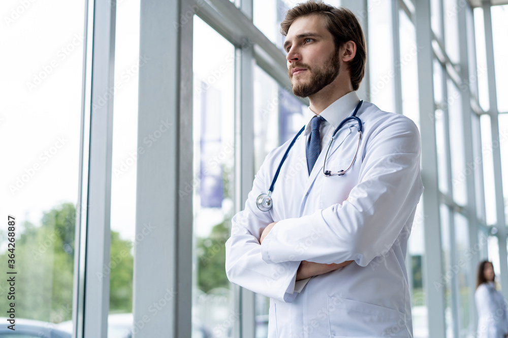 happy male medical doctor portrait in hospital. happy male medical doctor portrait in hospital.