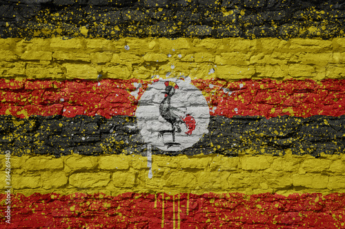 painted big national flag of uganda on a massive old brick wall