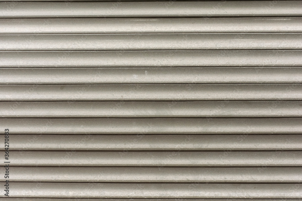 old shabby roller shutters designed to protect windows from vandals on a dark street old shabby roller shutters designed to protect windows from vandals on a dark street