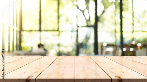 Empty wooden top table with blur coffee shop background