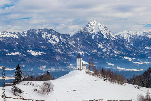 Church of Saint Primus and Felician Jamnik Slovenia winter snow mountain Storžič