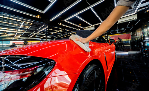 Car service worker applying nano coating on a car detail