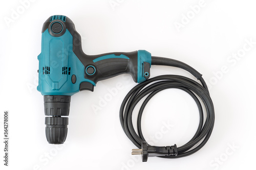 Blue power drill with black electric wire on an isolated white background