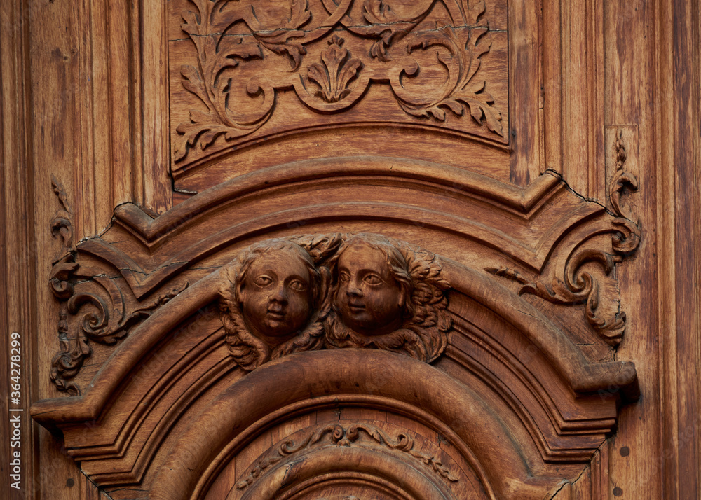 angels carved in wood on the church door