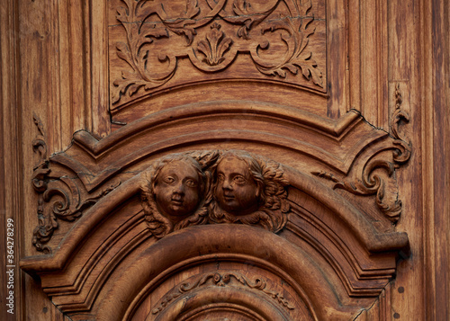angels carved in wood on the church door
