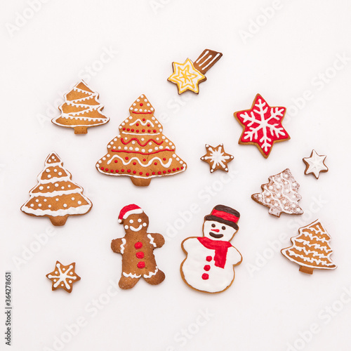 handmade gingerbread cookies in the form of snowflake, snowman,christmas trees and ginger man on white background.