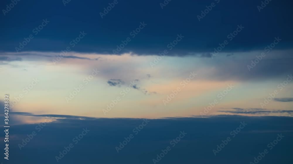 Colorful clouds moving fast in time-lapse. Idyllic cloudy heaven background. Timelapse of beautiful clouds in sky in evening sunlight, Sunset, rain clouds right before storm Colorful clouds moving fast in time-lapse. Idyllic cloudy heaven background. Timelapse of beautiful clouds in sky in evening sunlight, Sunset, rain clouds right before storm