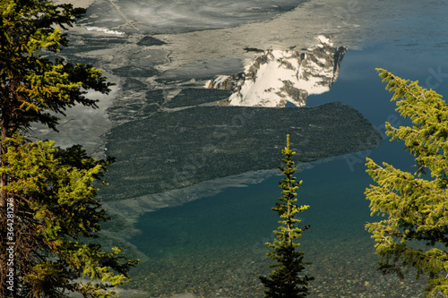 Mountain peak reflection in ice covered lake;  Grand Teton NP;  Wyoming photo