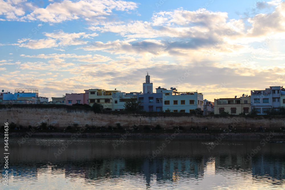 View of the embankment, Bassin Souani, colorful houses and a mosque. Menkes. Morocco