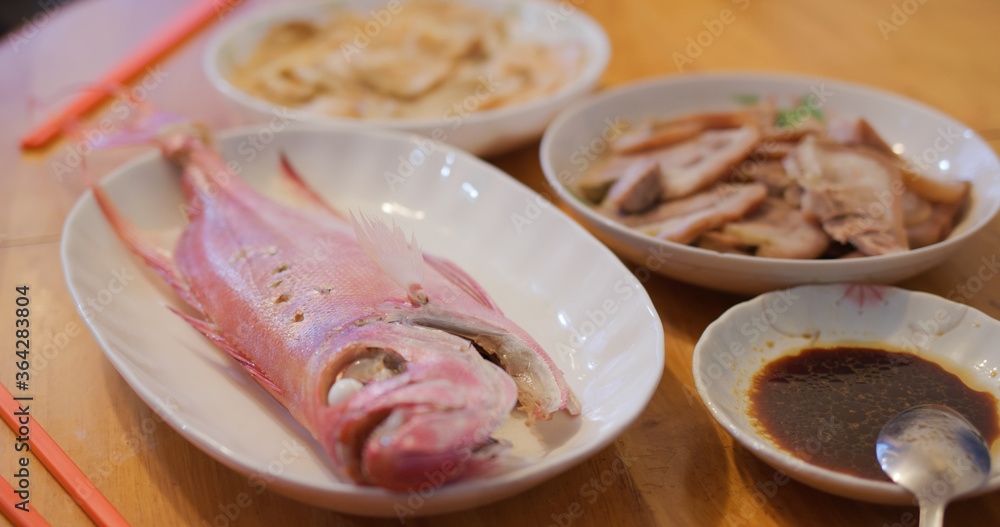 Hong Kong style home cuisine, family dinner concept, steamed fish, fry vegetable and meat Hong Kong style home cuisine, family dinner concept, steamed fish, fry vegetable and meat