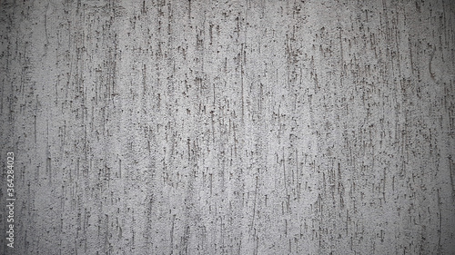 Grey grunge textured wall. White old cement concrete background. Surface of plaster, stucco. Rough cracked texture. Close up, top view