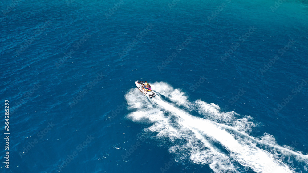 defaultAerial drone photo of stunt man performing extreme stunts with water craft over the ocean at dusk defaultAerial drone photo of stunt man performing extreme stunts with water craft over the ocean at dusk