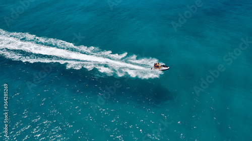 defaultAerial drone photo of stunt man performing extreme stunts with water craft over the ocean at dusk © aerial-drone