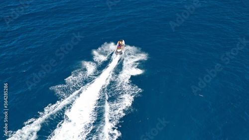 defaultAerial drone photo of stunt man performing extreme stunts with water craft over the ocean at dusk