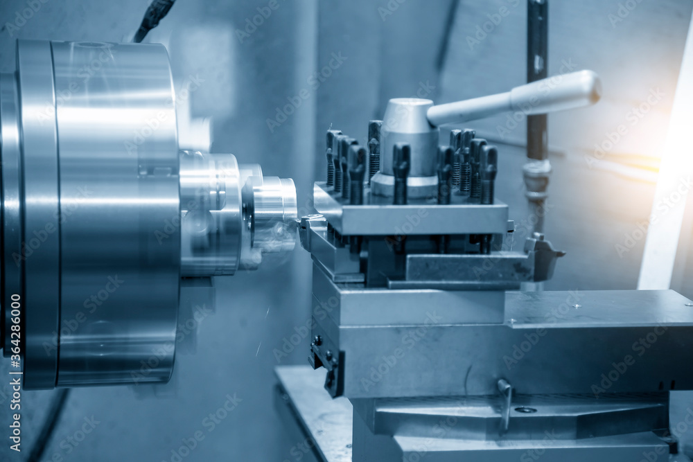 The operation of lathe machine cutting the brass shaft parts with the cutting tools. The metalworking process by turning machine. The operation of lathe machine cutting the brass shaft parts with the cutting tools. The metalworking process by turning machine.