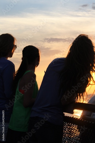 silhouette of a sisters at sunset